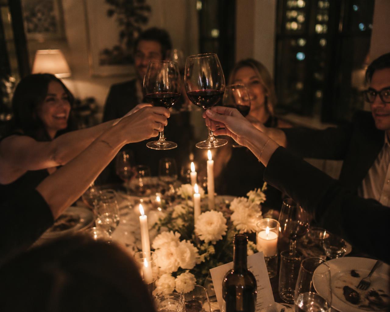 Guests toasting at a candlelit table